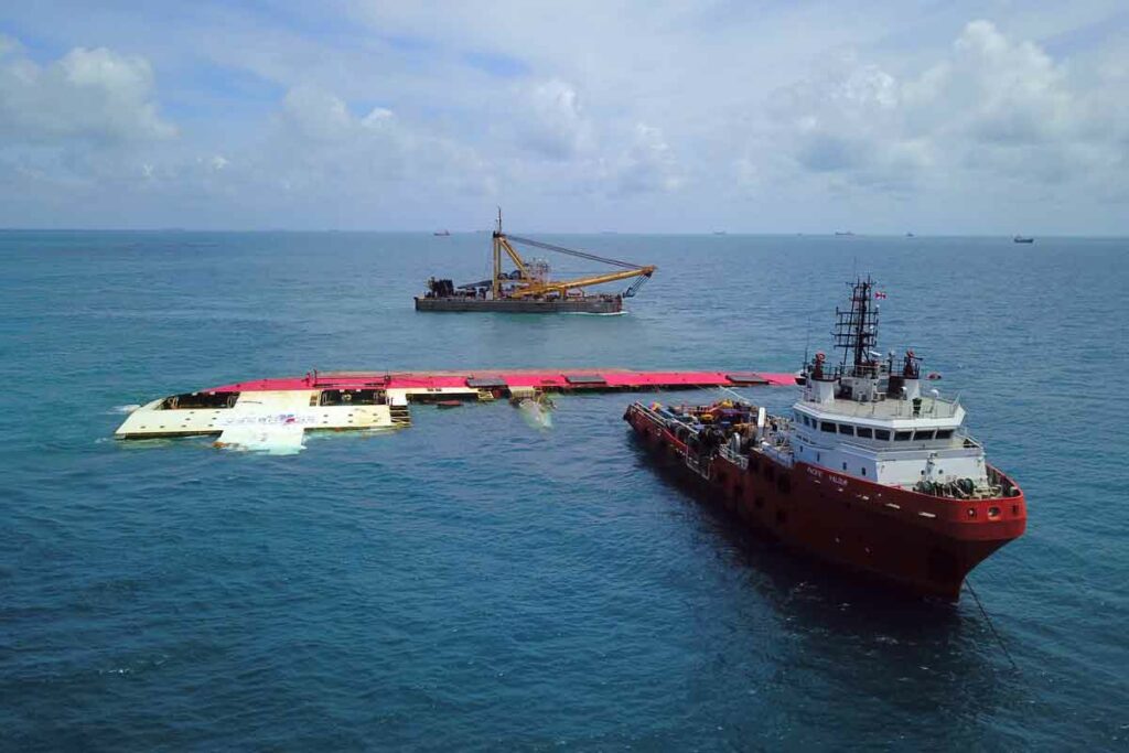 capsized ship and response boat